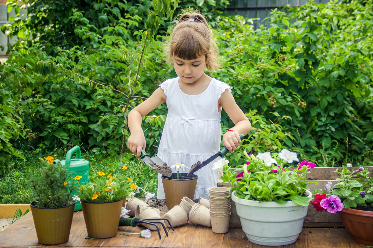 A little girl is planting flowers The young gardener Selective focus